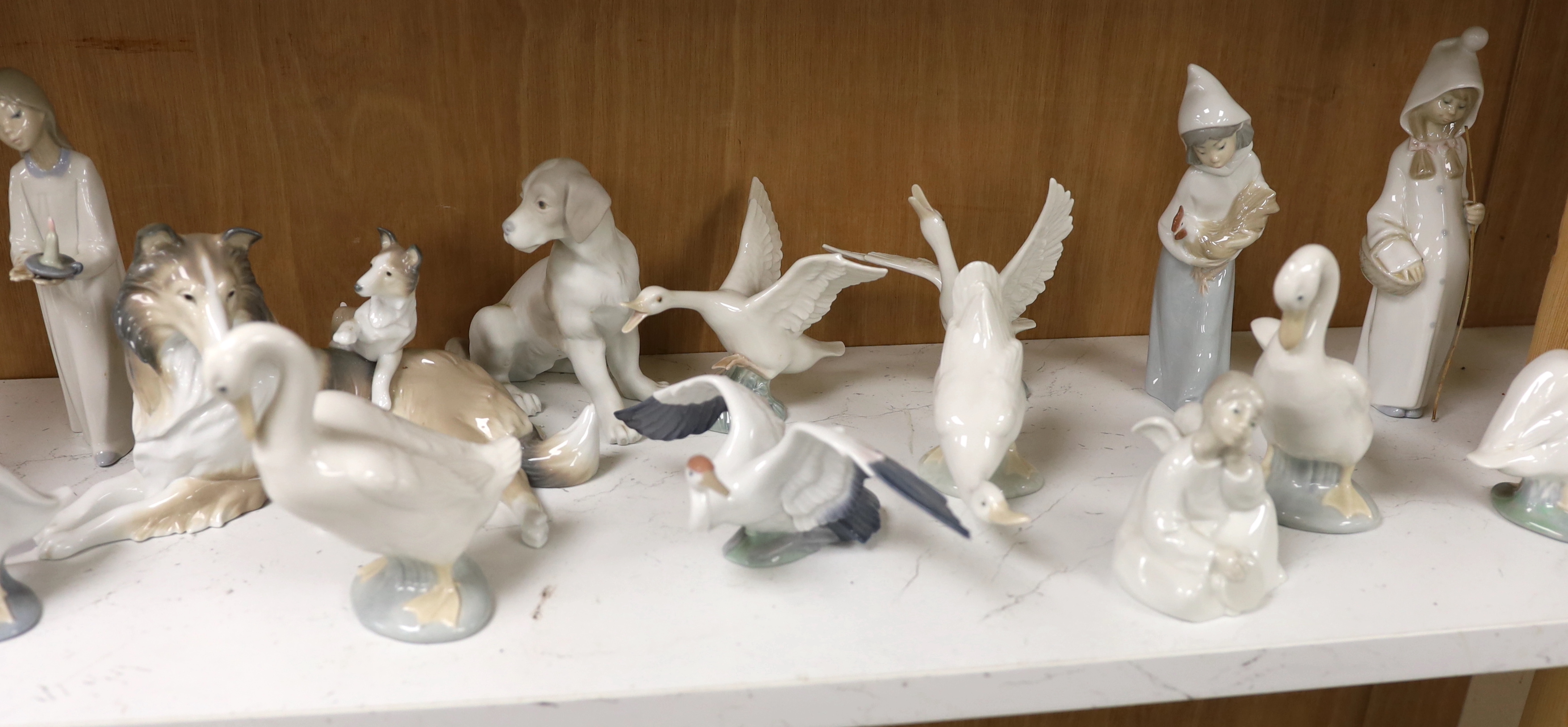 Twenty pieces of Lladro and Nao porcelain, tallest 31cm